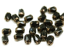 6x4mm Black rice czech glass fire polished beads golden ends, 25pc