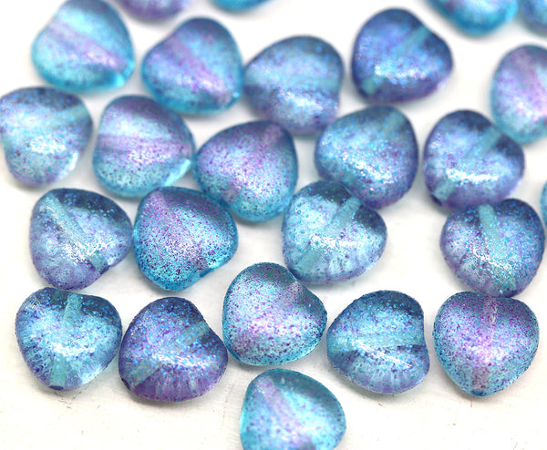 Blue and purple heart-shaped beads on a white background