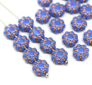 Blue floral beads with copper accents on a white background