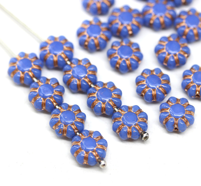 Blue floral beads with copper accents on a white background