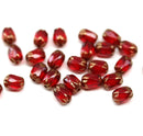 6x4mm Dark red rice czech glass fire polished small oval beads golden ends 25pc