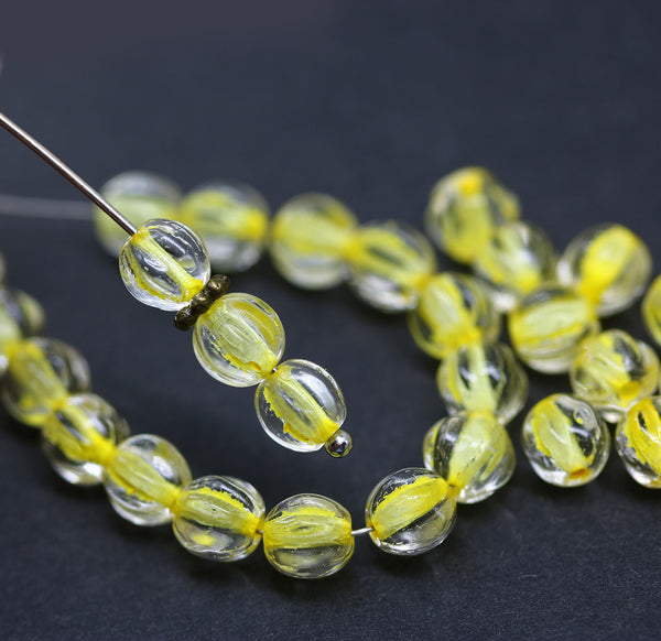 6mm Crystal clear czech glass melon shape beads, yellow colored holes - 30pc