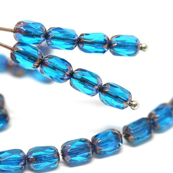 6x4mm Capri blue czech glass fire polished rice beads gold ends 25pc